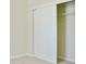 Bedroom closet features neutral walls, carpet, shelving, and sliding doors at 168 Ellis Dr, Conyers, GA 30012
