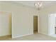 Large bedroom featuring carpeted floors, white trim, a ceiling fan, and multiple doors at 168 Ellis Dr, Conyers, GA 30012
