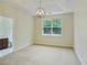 Bright main bedroom with tray ceiling, contemporary light fixture, and large window with views at 168 Ellis Dr, Conyers, GA 30012