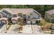 An elevated view of the lovely townhome, with brick accents and attached garages in a serene setting at 168 Ellis Dr, Conyers, GA 30012