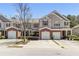 Charming townhome with a brick front, attached garage, and a well-maintained lawn at 168 Ellis Dr, Conyers, GA 30012