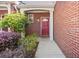 Close-up of the townhome's inviting entryway, featuring a red front door and manicured landscaping at 168 Ellis Dr, Conyers, GA 30012