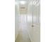 Long hallway with neutral walls, carpet, multiple doors, and overhead lighting at 168 Ellis Dr, Conyers, GA 30012