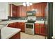 Well-equipped kitchen with stainless steel appliances, dark wood cabinets, and white countertops at 168 Ellis Dr, Conyers, GA 30012