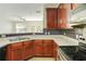 Bright kitchen with stainless appliances, dark cabinets, and a view of the adjacent living area at 168 Ellis Dr, Conyers, GA 30012