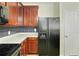 Kitchen features sleek countertops, cherry cabinets, stainless steel appliances and refrigerator with ice maker at 168 Ellis Dr, Conyers, GA 30012