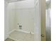 Spacious laundry room area features tile flooring, white trim, and a wire shelf for storage at 168 Ellis Dr, Conyers, GA 30012