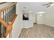 Spacious living room with a staircase, light hardwood floors, stylish lighting, and an open kitchen view at 168 Ellis Dr, Conyers, GA 30012