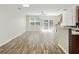 Bright open-concept living space with wood floors, a ceiling fan, and sliding doors to the backyard at 168 Ellis Dr, Conyers, GA 30012