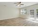 Living room with light hardwood floors, ceiling fan, lots of natural light, and glass doors to the outside at 168 Ellis Dr, Conyers, GA 30012