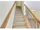 Carpeted staircase featuring stylish banister and iron balusters leading to the upper level at 168 Ellis Dr, Conyers, GA 30012
