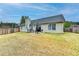 Backyard with patio, seating, and lush lawn at 1965 Winnstead Pl, Loganville, GA 30052