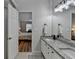 Bathroom featuring a dual-sink vanity with granite counters next to the door to the main bedroom at 1965 Winnstead Pl, Loganville, GA 30052