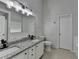 Bathroom with a dual-sink vanity, granite countertop, white cabinetry, and modern fixtures at 1965 Winnstead Pl, Loganville, GA 30052
