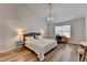 Bright bedroom featuring hardwood floors, a ceiling fan, and natural light at 1965 Winnstead Pl, Loganville, GA 30052