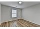 Bright bedroom with hardwood floors and natural light from window at 1965 Winnstead Pl, Loganville, GA 30052