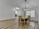 Bright dining area with hardwood floors, a view of living area, and modern lighting at 1965 Winnstead Pl, Loganville, GA 30052