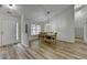 Open concept dining room featuring hardwood floors, bright light, and a large dining table at 1965 Winnstead Pl, Loganville, GA 30052