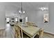 Dining area with hardwood floors, an open concept to the living room, and modern decor at 1965 Winnstead Pl, Loganville, GA 30052