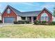 Inviting home featuring brick accents, manicured bushes, and a welcoming front entrance at 1965 Winnstead Pl, Loganville, GA 30052