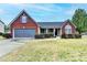 Charming brick home with well-maintained landscaping and a two-car garage at 1965 Winnstead Pl, Loganville, GA 30052