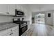 Modern kitchen with stainless steel gas range and sliding glass door at 1965 Winnstead Pl, Loganville, GA 30052