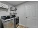 Laundry room featuring modern stainless-steel washer and dryer with shelf for storage at 1965 Winnstead Pl, Loganville, GA 30052