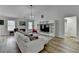 Bright living room with hardwood floors, white furniture, fireplace, and lots of open space at 1965 Winnstead Pl, Loganville, GA 30052