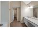 Bright bathroom featuring a marble top vanity and a tile floor at 272 Ascott Ln, Woodstock, GA 30189