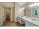 Bathroom featuring double sinks, white cabinets, and a walk-in closet at 272 Ascott Ln, Woodstock, GA 30189