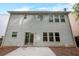 Back exterior of a two-story home with vinyl siding and a concrete patio at 272 Ascott Ln, Woodstock, GA 30189