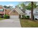 Charming two-story home boasts a brick facade and a well-manicured front yard with lush landscaping at 272 Ascott Ln, Woodstock, GA 30189