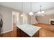 Kitchen island with granite countertops, providing seating and prep space, open to the living room and stainless appliances at 272 Ascott Ln, Woodstock, GA 30189