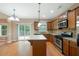 Well-appointed kitchen featuring an island, granite countertops, stainless steel appliances, and hardwood flooring at 272 Ascott Ln, Woodstock, GA 30189