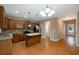 Modern kitchen with island, stainless steel appliances, granite countertops, and ample cabinet space with hardwood flooring at 272 Ascott Ln, Woodstock, GA 30189