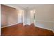 Open living space with hardwood floors and neutral walls, seamlessly connecting to the kitchen and dining areas at 272 Ascott Ln, Woodstock, GA 30189