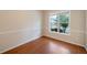 Comfortable living room showcasing a bright window view and beautiful hardwood floors, creating a cozy ambiance at 272 Ascott Ln, Woodstock, GA 30189