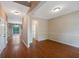 Bright open-concept living area with hardwood floors and natural light, seamlessly connecting to other spaces at 272 Ascott Ln, Woodstock, GA 30189