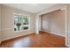 Inviting living room featuring a large window that fills the room with light and showcases the hardwood floors at 272 Ascott Ln, Woodstock, GA 30189
