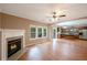 Open-concept living room and kitchen featuring a fireplace, hardwood floors, natural light, stainless steel appliances and breakfast bar at 272 Ascott Ln, Woodstock, GA 30189