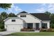 Charming two-story home featuring a symmetrical facade, attached garage, and professionally landscaped front yard at 341 Sobeck Way, Canton, GA 30115
