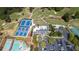 Stunning aerial view of a property showcasing tennis courts, a pool, clubhouse and manicured golf course at 890 Muirfield Rdg, Marietta, GA 30068