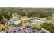 Scenic aerial view highlighting a pool, tennis courts, and lush golf course surrounded by mature trees at 890 Muirfield Rdg, Marietta, GA 30068