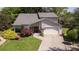 Aerial view of a charming home featuring a well-manicured lawn, complemented by vibrant flowers and a double-door entryway at 890 Muirfield Rdg, Marietta, GA 30068