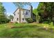 Exterior backyard showing a well-manicured lawn, mature trees, and garden beds at 890 Muirfield Rdg, Marietta, GA 30068