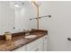 Bathroom featuring a granite counter top, white cabinetry, a decorative mirror, and a sink at 890 Muirfield Rdg, Marietta, GA 30068