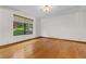 Bedroom featuring hardwood floors and a large window with views of lush greenery at 890 Muirfield Rdg, Marietta, GA 30068
