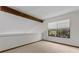 Bright bedroom with a large window, wood beam and neutral carpeting at 890 Muirfield Rdg, Marietta, GA 30068