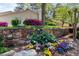 Stone wall with colorful spring flowers marks the entrance to PineCrest at 890 Muirfield Rdg, Marietta, GA 30068