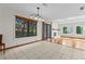 Open dining room with tile flooring and a pass-through to the living room with a fireplace at 890 Muirfield Rdg, Marietta, GA 30068